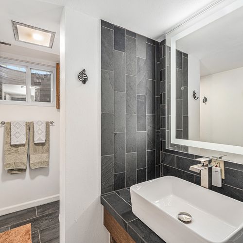 Step into the modern, spacious downstairs bathroom designed for comfort and style, featuring sleek finishes and plenty of room to refresh and unwind.