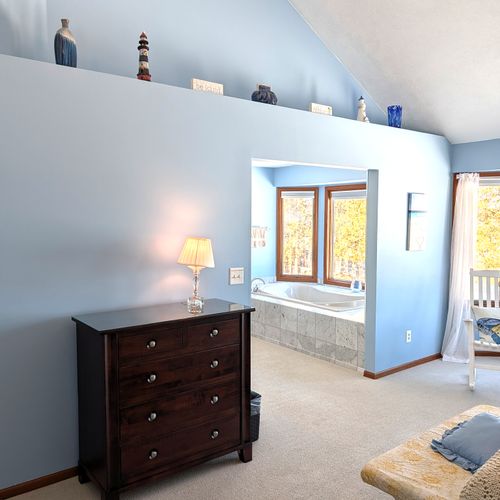 BEDROOM #2 (SECOND FLOOR):  The home has a huge primary bedroom on the second floor with a queen-size bed, private ensuite bathroom, and great views of Big Platte Lake!