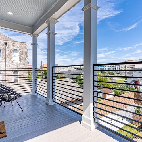 Covered balcony w/ open-air seating & sweeping city views.