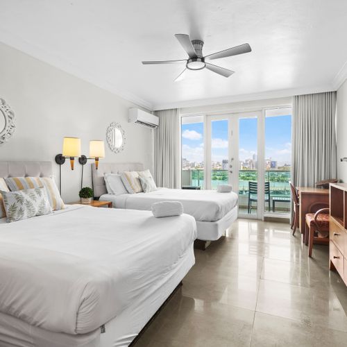 Spacious sleeping area with two inviting beds, adorned with tasteful decor and soft linens.