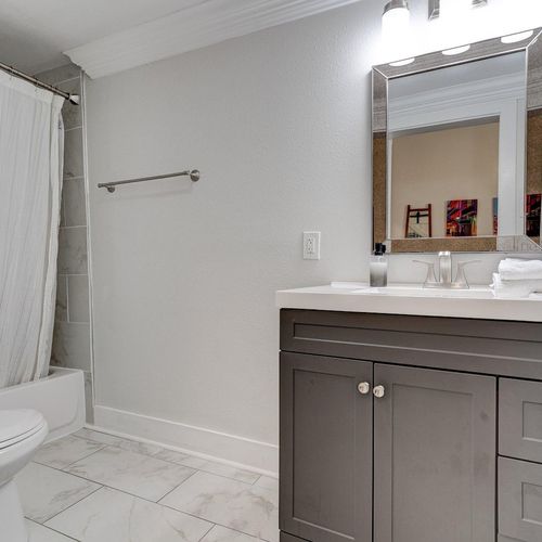 Clean, bright en suite bathroom w/ sink & tub/shower — a private escape after a long day.