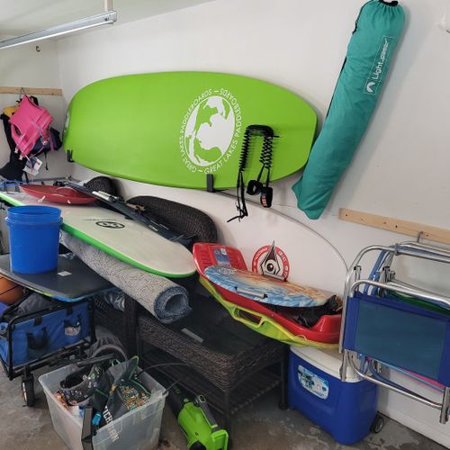 Exterior:  the fun water and beach toys in the garage, including 2 paddleboards, beach chairs, a cooler, sleds, a boogie board, and a wagon for taking things to the beach