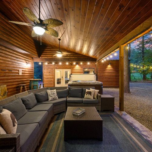The covered patio has an oversized outdoor sectional.