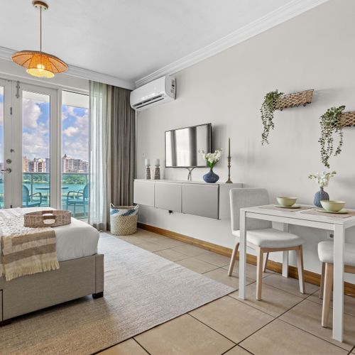 Bright living space with comfortable seating and direct balcony access. Relax and enjoy!
