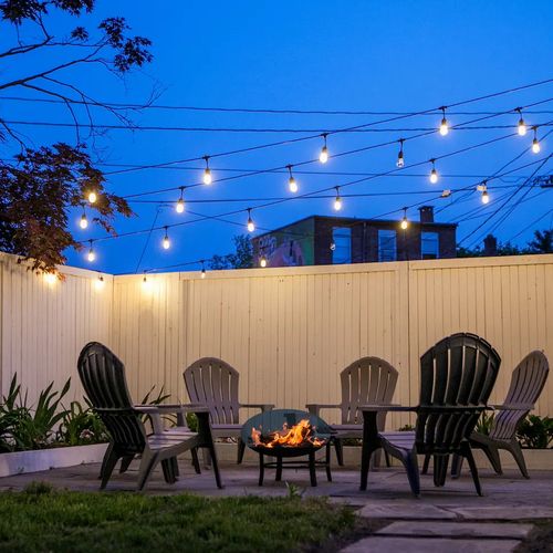 Unwind at night on the bluestone patio, perfect for bonfires under the lights in the heart of Kingston