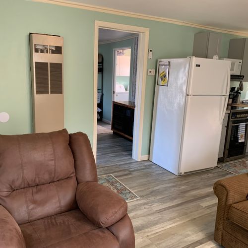 Living room:  living room with the kitchenette in the background