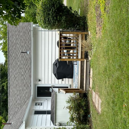 Exterior:  a closer shot of the backyard deck, which features a gas grill and outdoor dining furniture