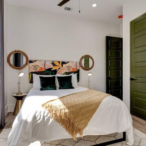 Cozy upstairs bedroom w/ bold décor, warm tones & a stylish flair.