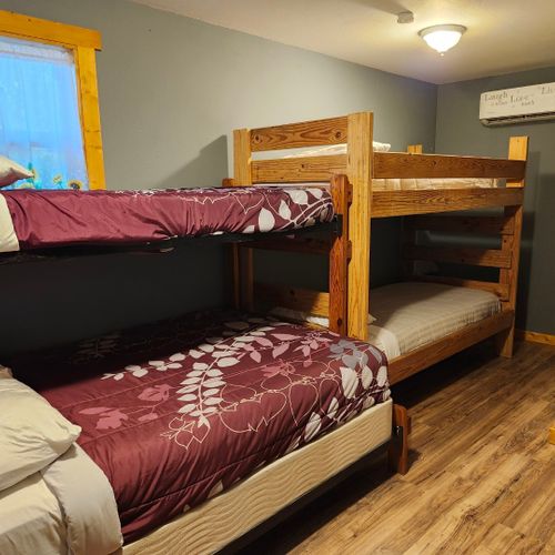 Main room:  the main room, which features 6 beds (5 twins and 1 double), a small dining table, and a small sink / kitchenette.