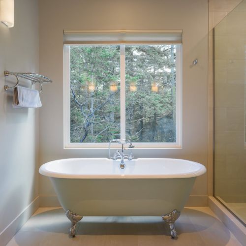 Master Bathroom clawfoot tub with beautiful views of the private forest outside.