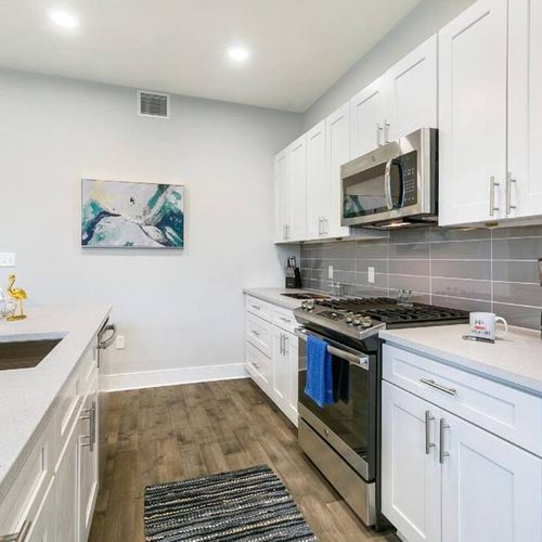 Stylish kitchen w/ subway tile backsplash, stainless range & plenty of counter space.