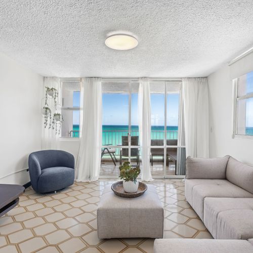 Beachfront Rental | Isla Verde 45 Relax in style! This beautifully appointed living room offers plush seating and direct access to your private balcony, providing an idyllic setting for enjoying the ocean breeze and views.