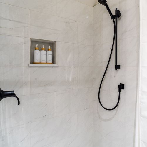 Enjoy this beautiful,  bright custom-tiled walk-in shower.