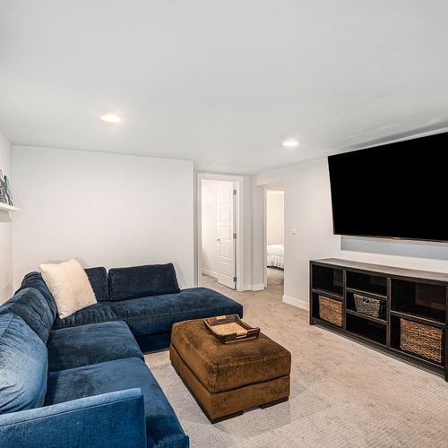 Enjoy a movie night in the living room with a large 75" flat-screen tv.