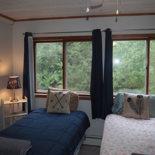 Bedroom #4 (second floor):  features 3 twin-size beds, nightstands with lamps, ceiling fan, closet, dresser, chair, and its own private television.