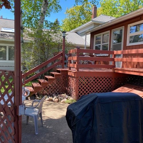 Exterior:  the backyard deck, dining area, and outdoor grill.