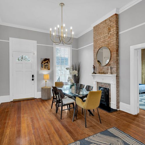 Gather in style! This beautifully designed open-plan dining and living area features exposed brick, modern furnishings, and plenty of natural light—perfect for hosting memorable meals and cozy nights in.