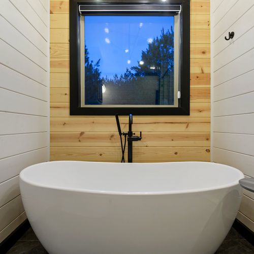 This oversized soaking tub plus a side table for all of the relaxation.