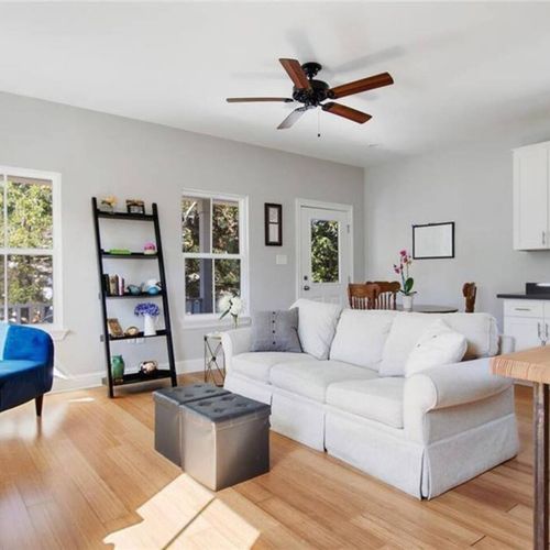 Relaxed living room w/ soft seating & natural light pouring in.