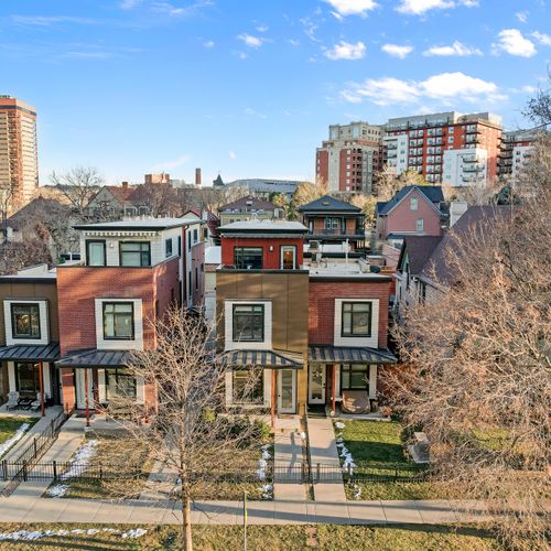 Vibrant neighborhood with colorful homes, tree-lined streets, and easy access to downtown