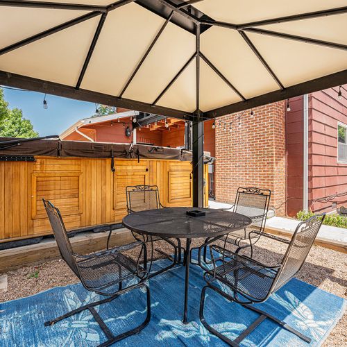 Outdoor seating under the pergola offers a shaded and inviting retreat, perfect for enjoying meals, relaxing with a book, or hosting gatherings amidst the natural beauty of the surroundings.