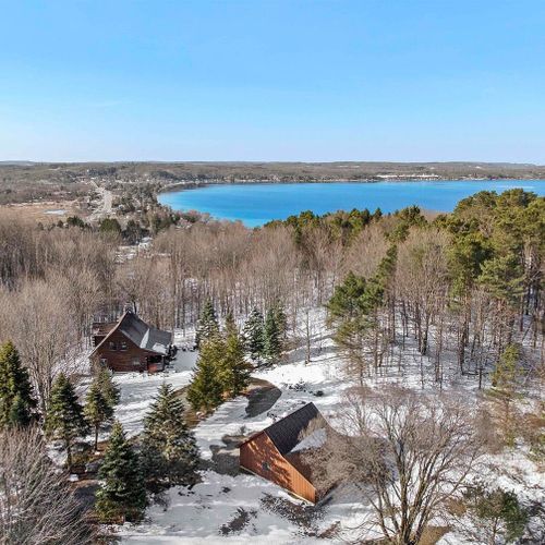 Exterior:  an aerial view of the cabin with crystal lake in the background.