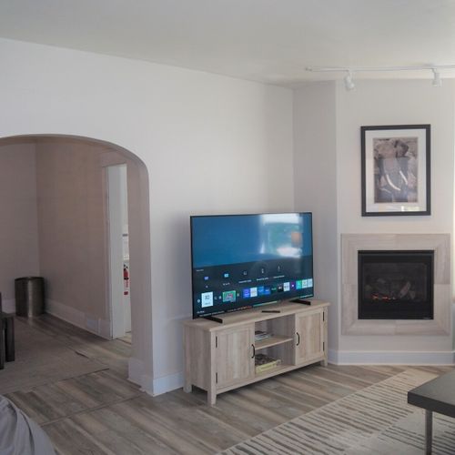 Living room:  gorgeous living room that features a gas fireplace and a large television with live streaming via hulu, netflix, and disney+.