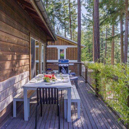 The balcony invites you to enjoy the outdoors in comfort. Fire up the BBQ for an alfresco meal, relax in the seating area with a drink, or soak up the fresh air surrounded by lush greenery.