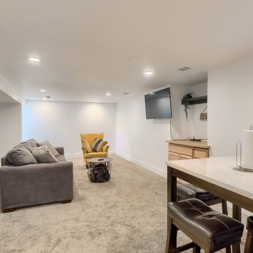 An additional dining table sits downstairs, with a mini fridge, microwave and widescreen tv for entertaining.