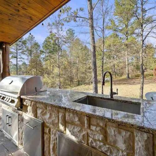 Grill, sink, mini fridge & ample prep-area are available on the covered patio.