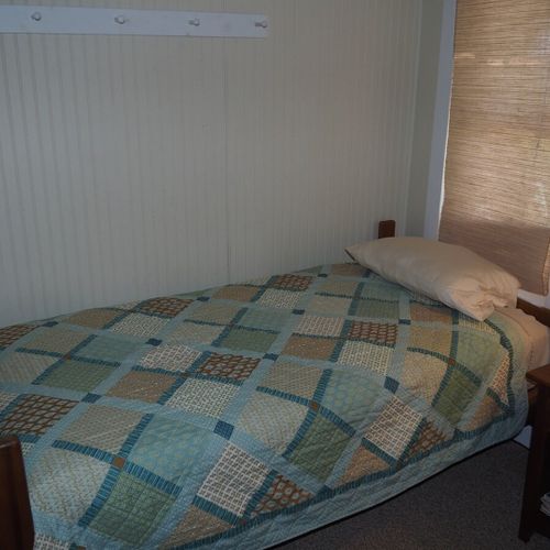 Bedroom #2:  features two twin beds, a nightstand, lamp, dresser, mirror, and closet.