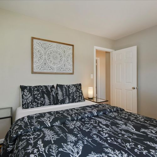 Another cozy bedroom sits upstairs with a queen bed and plenty of space to move around.