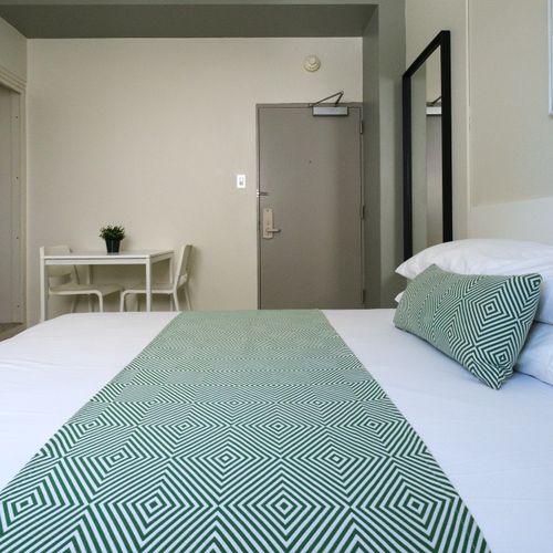 Whether you're here for work or leisure, our versatile bedroom provides a comfortable desk area, a cozy bed, and plenty of space to make yourself at home.