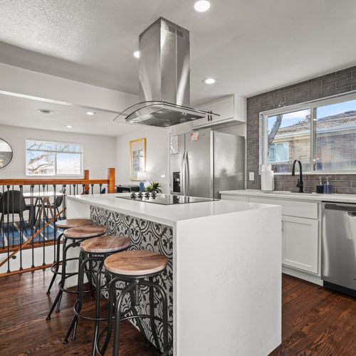 Central kitchen hub featuring bar stools for easy dining and gathering.