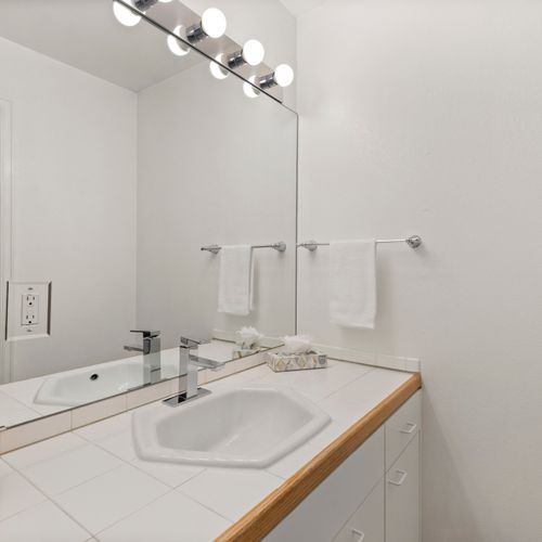 Stylish white walls and rustic accents create a spa-like atmosphere.