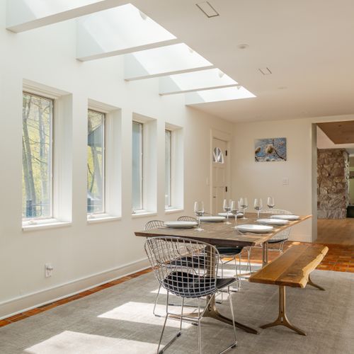 Skylights and wall-to-wall windows make this dining space an absolutely delight.