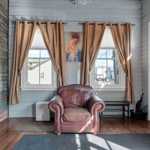 Sunny corner w/ a plush leather chair — the perfect spot to curl up & unwind.