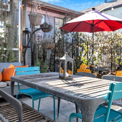 Private courtyard table set for an alfresco meal w/ good company.