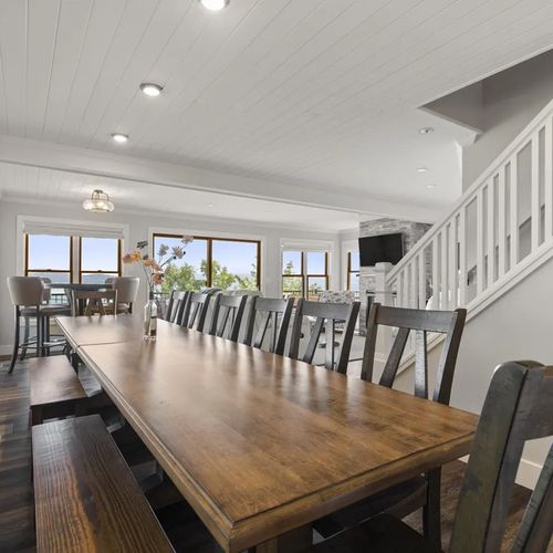 DINING AREA (MAIN FLOOR):  The home has a long dining table and secondary round dining table, which allows for the seating of up to 17 adults!