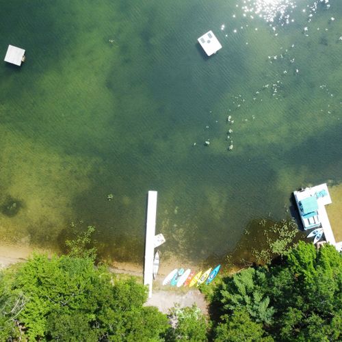 Exterior:  an aerial view of the private lakefront. Note that private swim raft at the top of the photo.