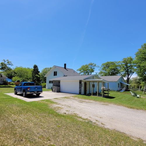 Exterior:  the large backyard, driveway, and parking area.