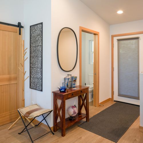 Slip off your shoes and settle in — the entry hall connects the main living spaces with quiet, unhurried style.