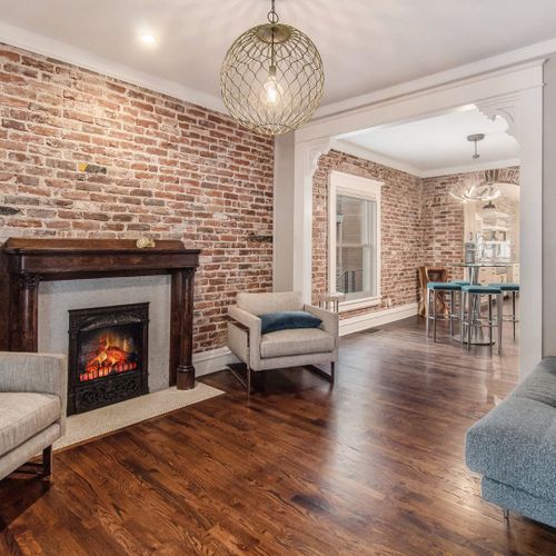 Prepare to be captivated upon entry into the original portion of this 1890 bungalow featuring exposed brick and original mantel.