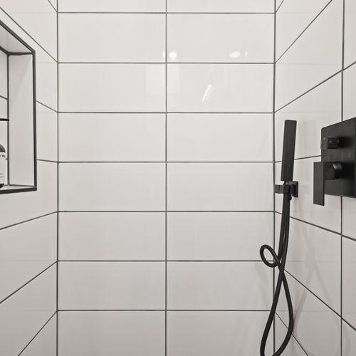 Walk-in shower, bright light, and a clean modern layout.