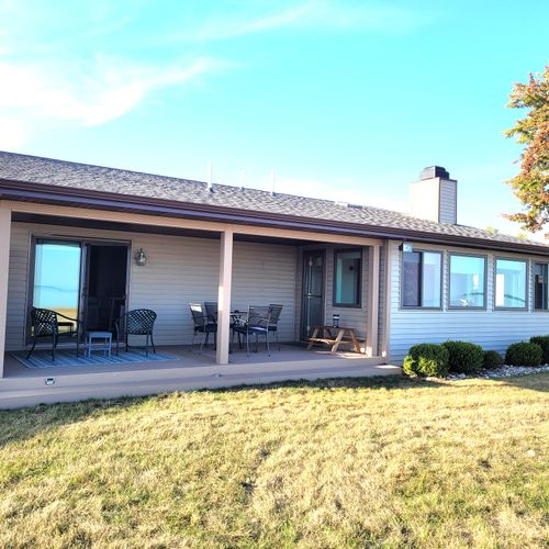 EXTERIOR:  Another view of the back of the house and the backyard patio that faces Lake Huron
