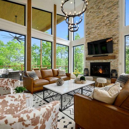 A chandelier and stone fireplace are at the heart of the living room!