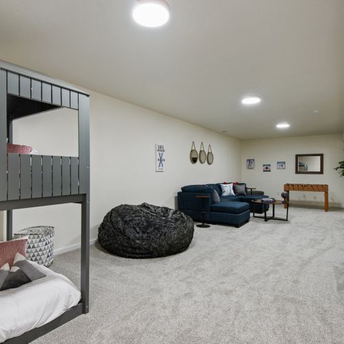 Bedroom 4: the second living space downstairs doubles as an additional bedroom and play space for the kiddos!