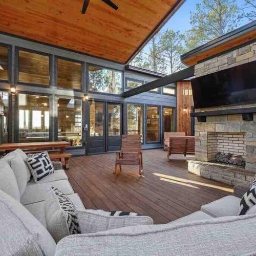 An oversized outdoor sectional placed around the fireplace and tv!