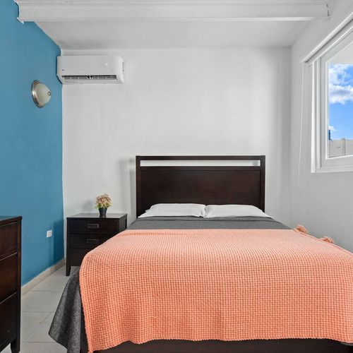 Experience the contemporary charm of this bedroom, equipped with air conditioning and generous storage capacity to accommodate all your items.