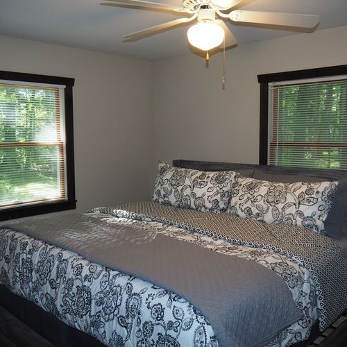 Bedroom #1 (main floor):  features a king-size bed, ceiling fan, dresser, mirror, closet, and a private television with live streaming via roku.